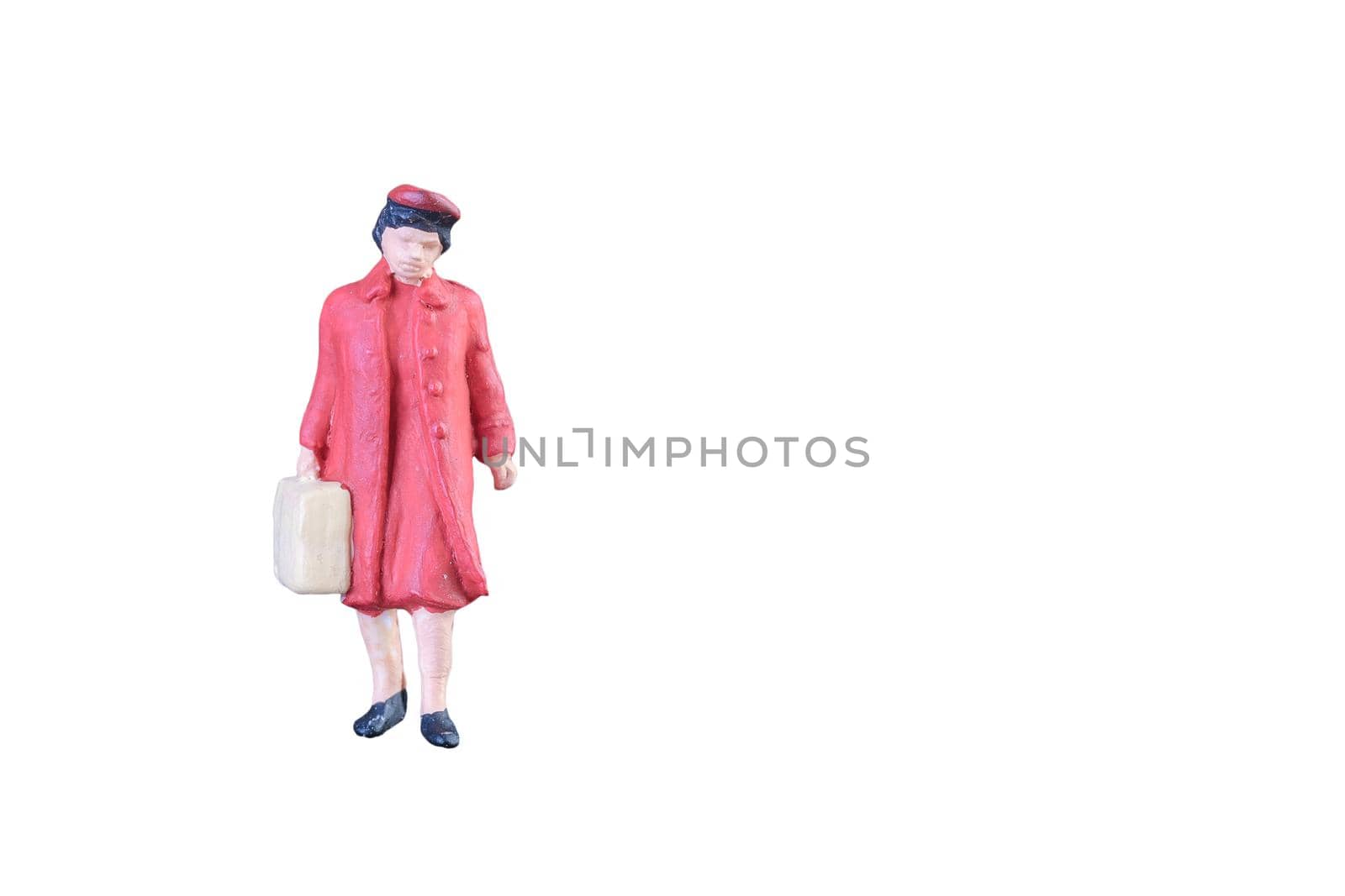 Close up of Miniature people isolated with clipping path on white background. by Nuamfolio