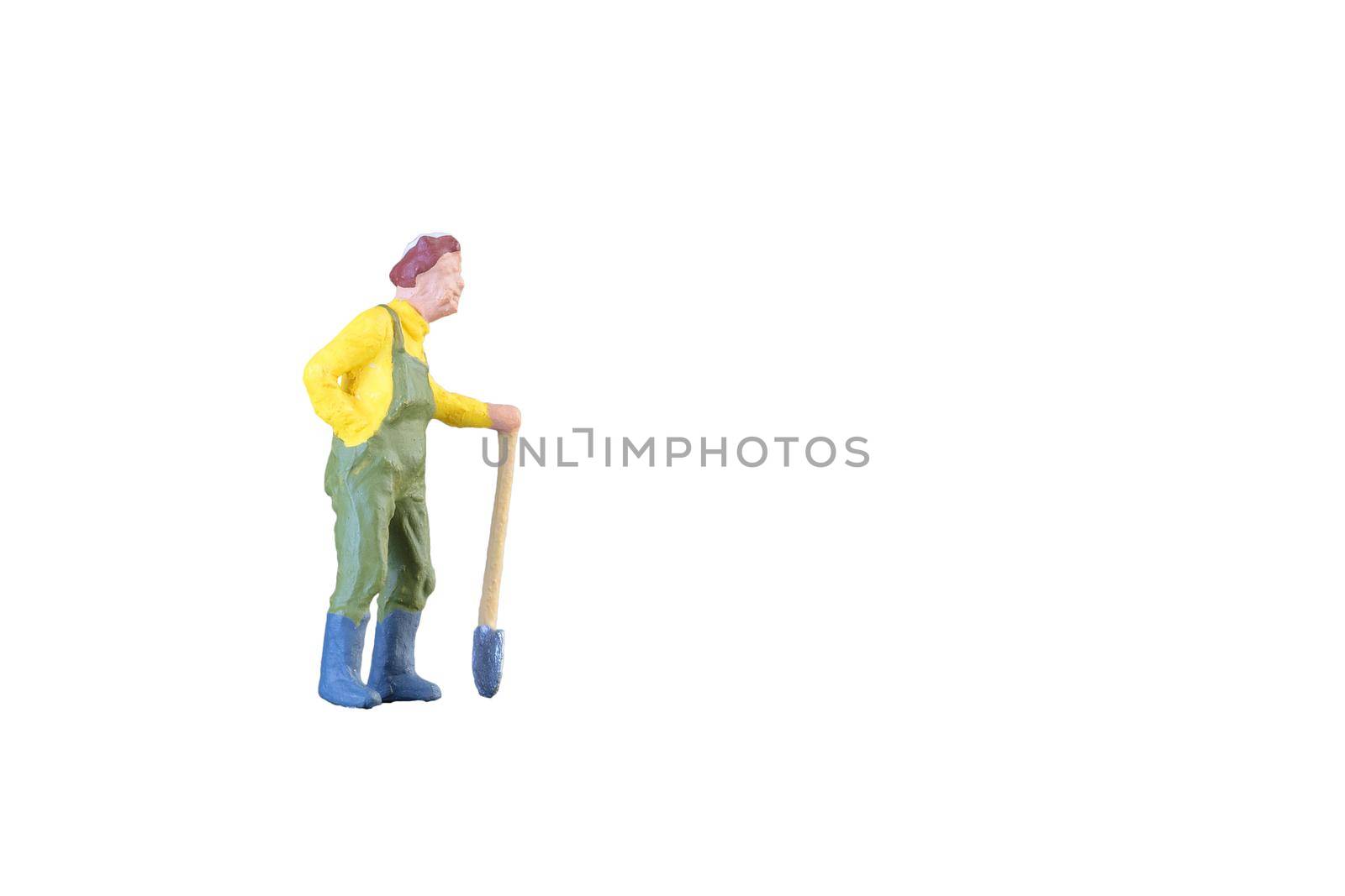 Close up of Miniature farmer people isolated with clipping path on white background . Elegant Design with copy space for placement your text, mock up for farmer and gradening concept.