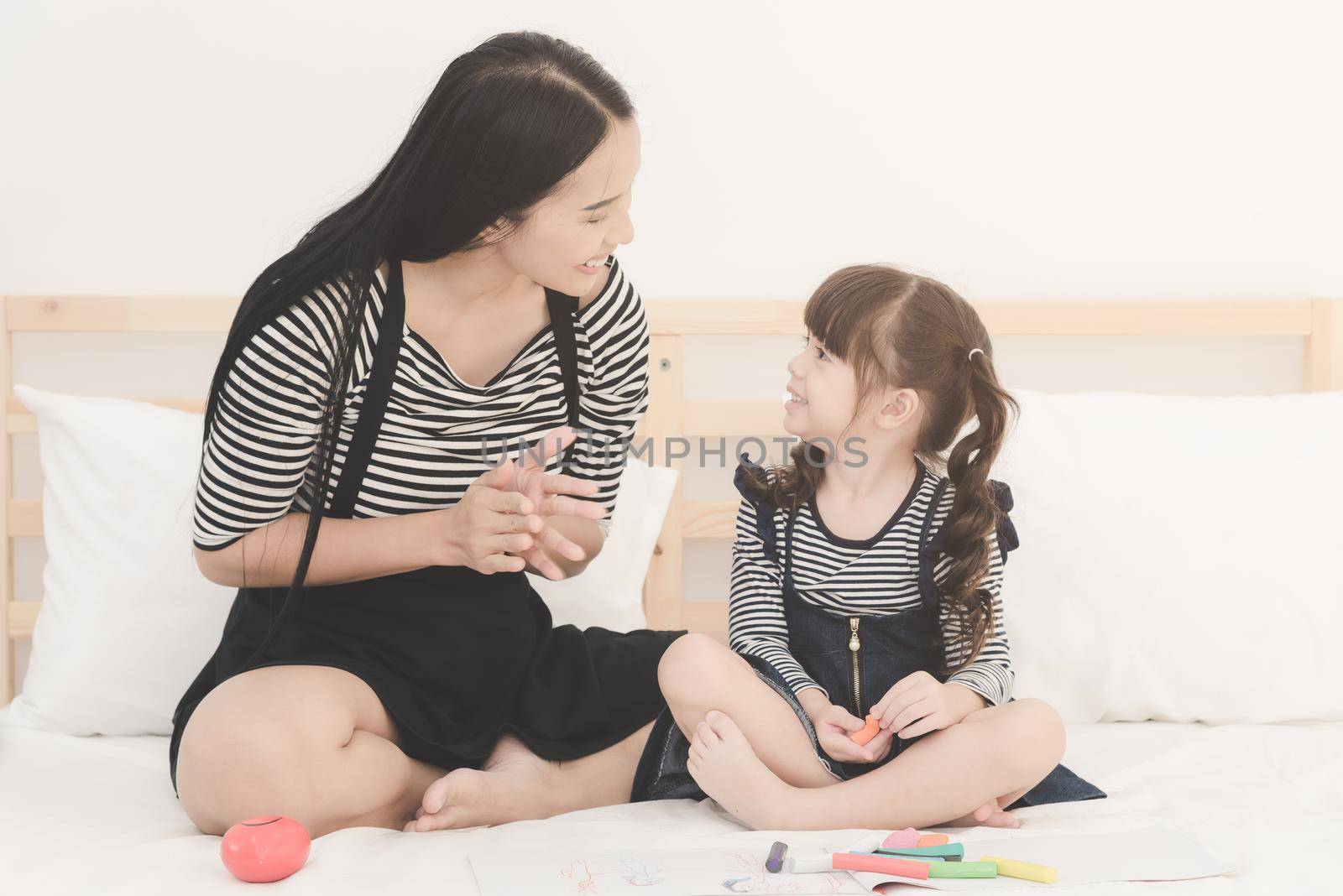 Happy loving family, asian young mother playing with her daughter in kid's room by Nuamfolio