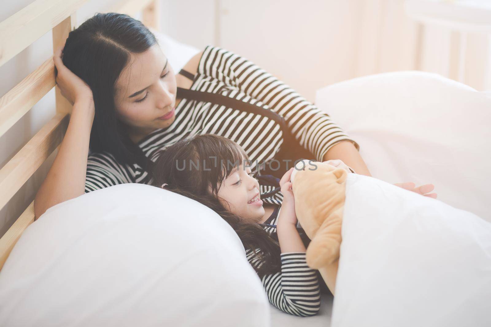 Happy loving family, asian young mother playing with her daughter in kid's room. Photo design for family, kids and happy people concept.