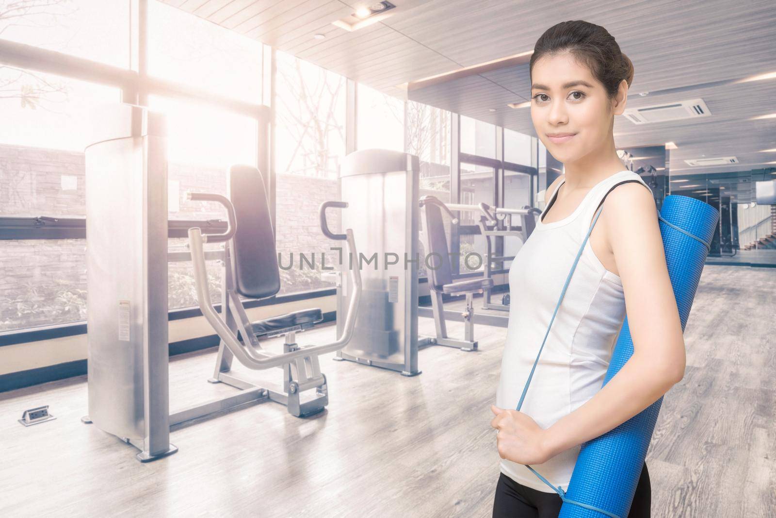 Asian healthy woman ready to exercising at sport gym, girl doing sport indoor.Photo design for fitness sporty woman and health care concept. by Nuamfolio