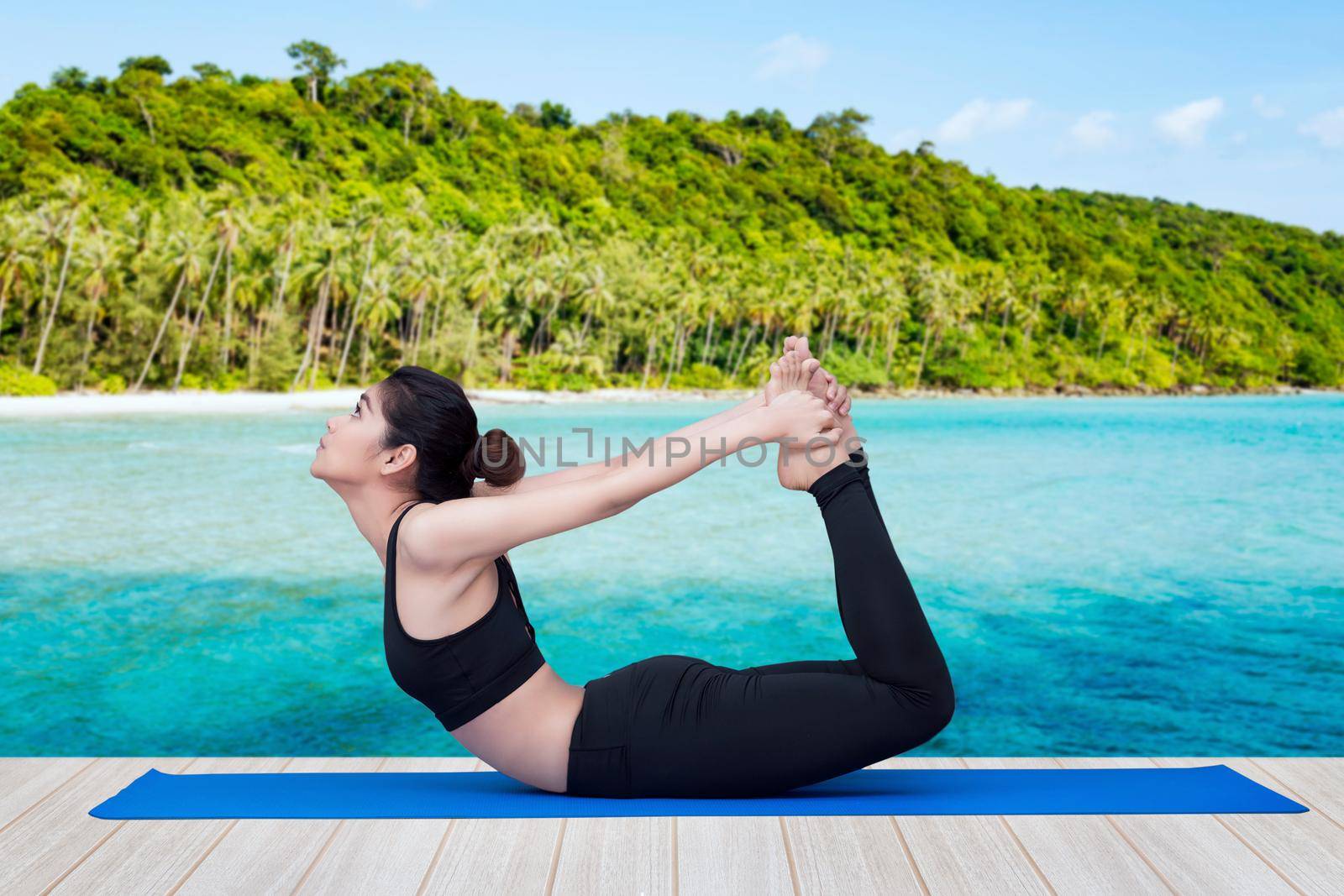 Asian healthy woman enjoy practicing yoga pose at tropical sea beach. Photo design for fitness sporty woman and health care concept by Nuamfolio