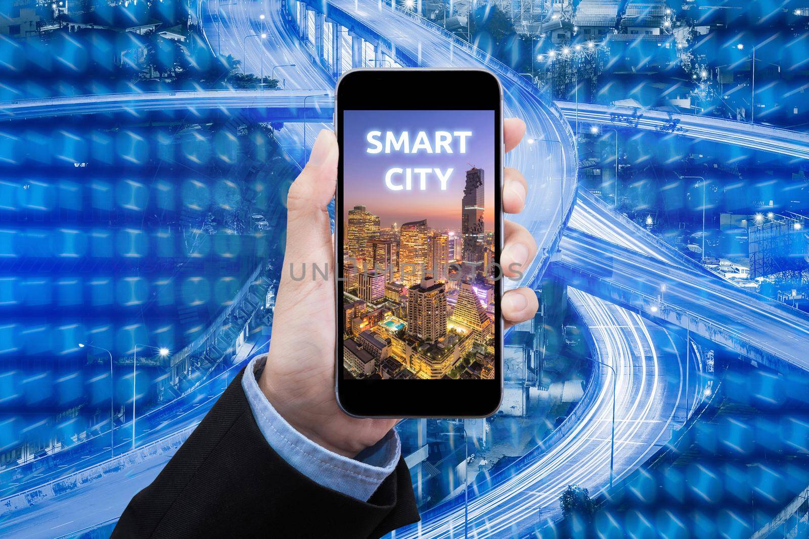 Business woman show Smart city on smart mobile phone with big data technology in background for internet of things technology concept.