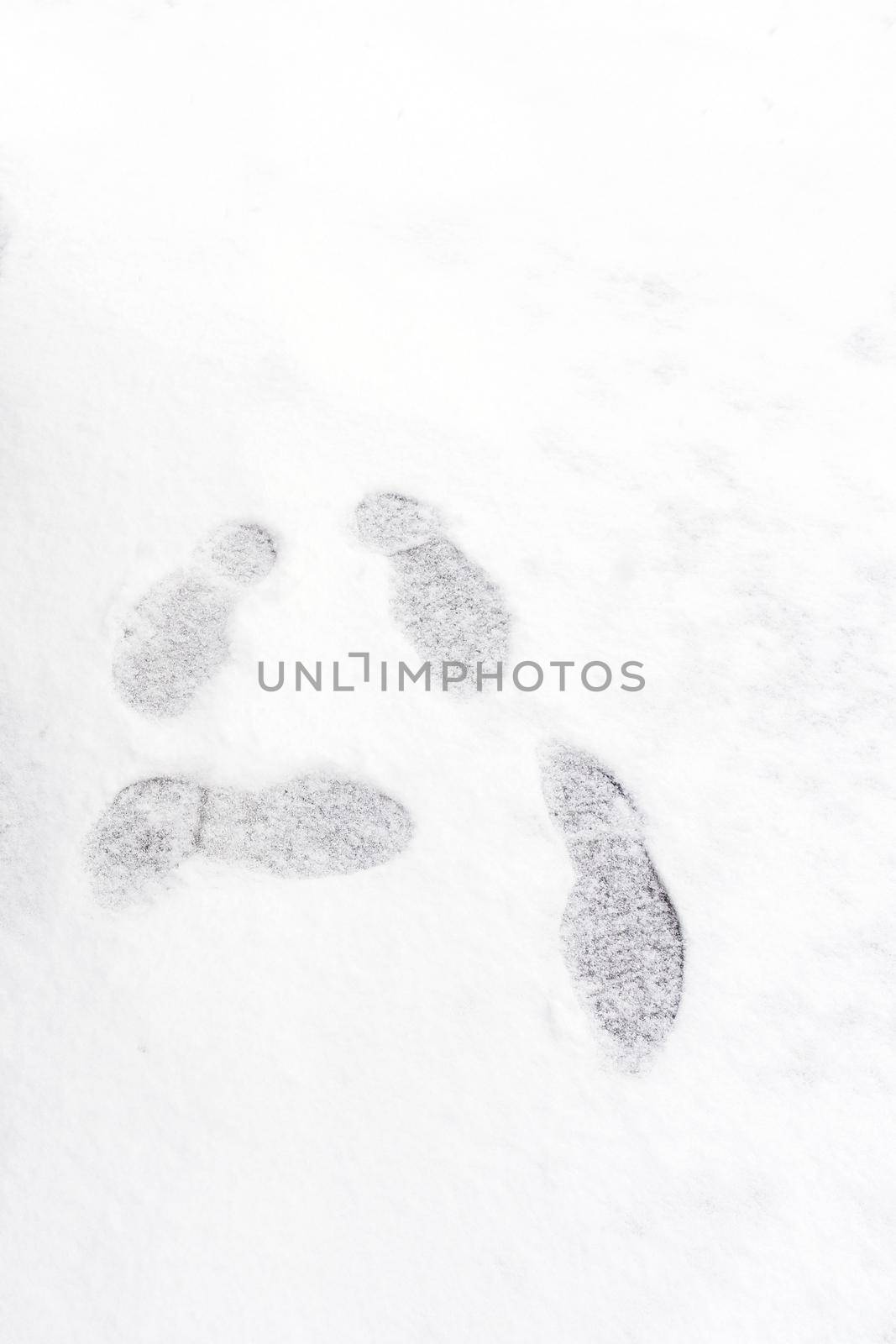 Footprint on fresh white snow falling at public park in winter season in Tokyo,Japan. Elegant design with copy space for add your text or art work by Nuamfolio