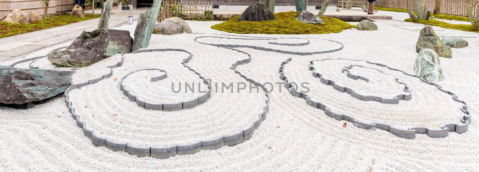 Japanese zen garden meditation stone in lines sand for relaxation balance and harmony spirituality or wellness in Kyoto,Japan by Nuamfolio