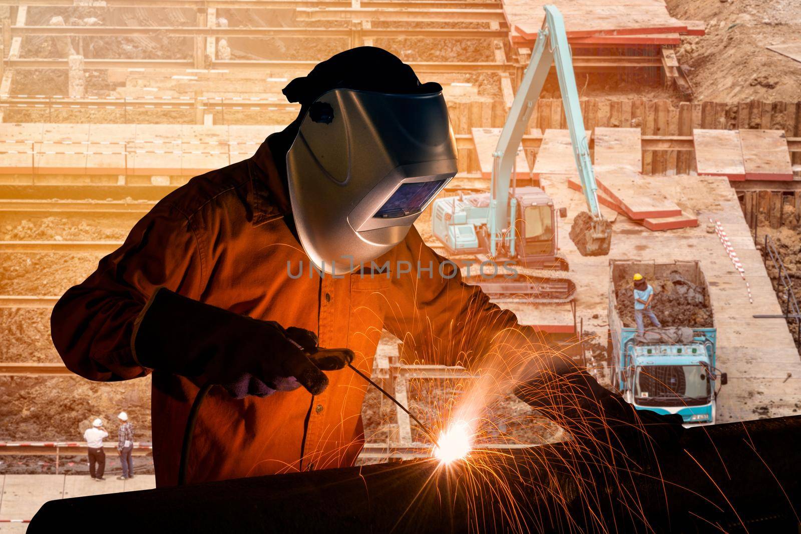 Welding worker welding steel structure with construction crane and building at construction site for construction industrial work concept. by Nuamfolio