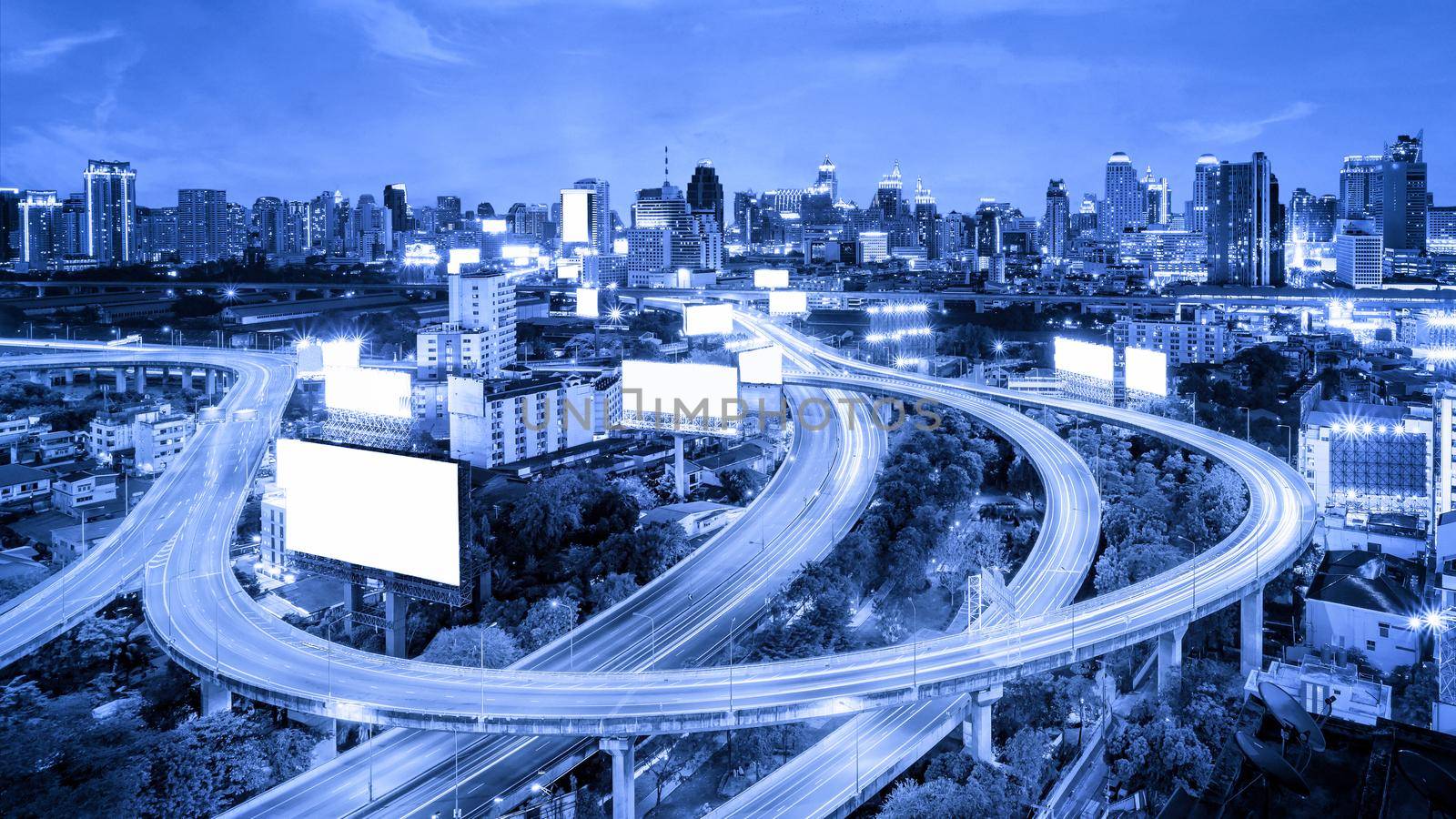 Vehicle transportation by road in big city with blue tone . Road is the main infrastructure for transportation for travel and business transportation.