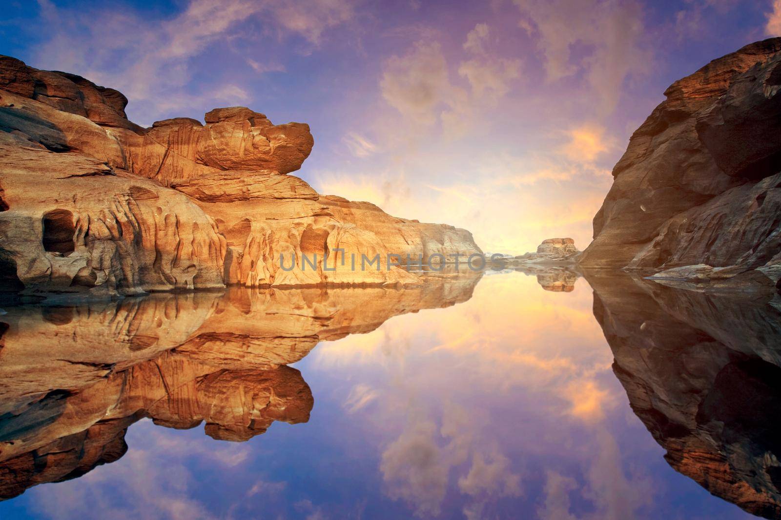 Nature Landscape view of Sand dunes and rock field with water reflection at Sam Phan Bok a canyon by the mekong river in grand canyon of Thailand. by Nuamfolio