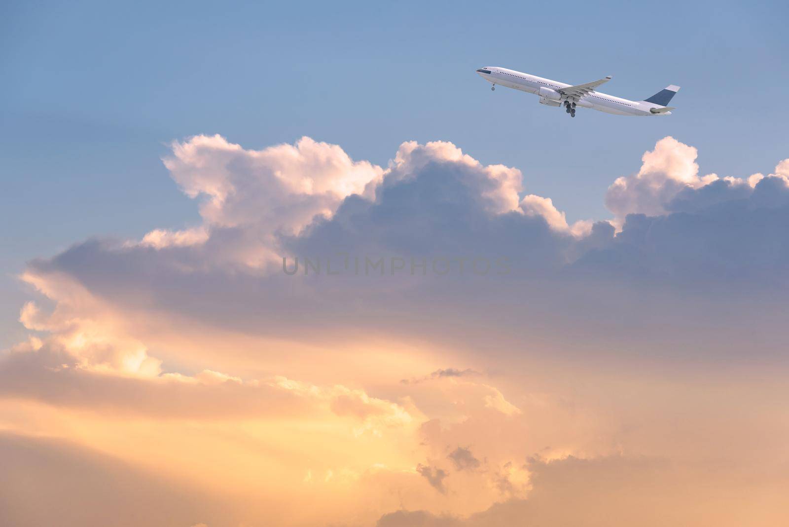 Commercial airplane flying over sunrise sky and clouds. Elegant Design with copy space for travel concept.
