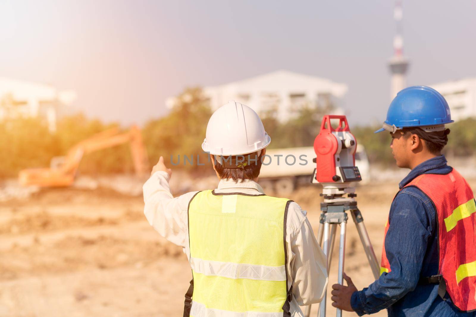 Construction engineer with foreman worker checking construction site for new Infrastructure construction project by Nuamfolio