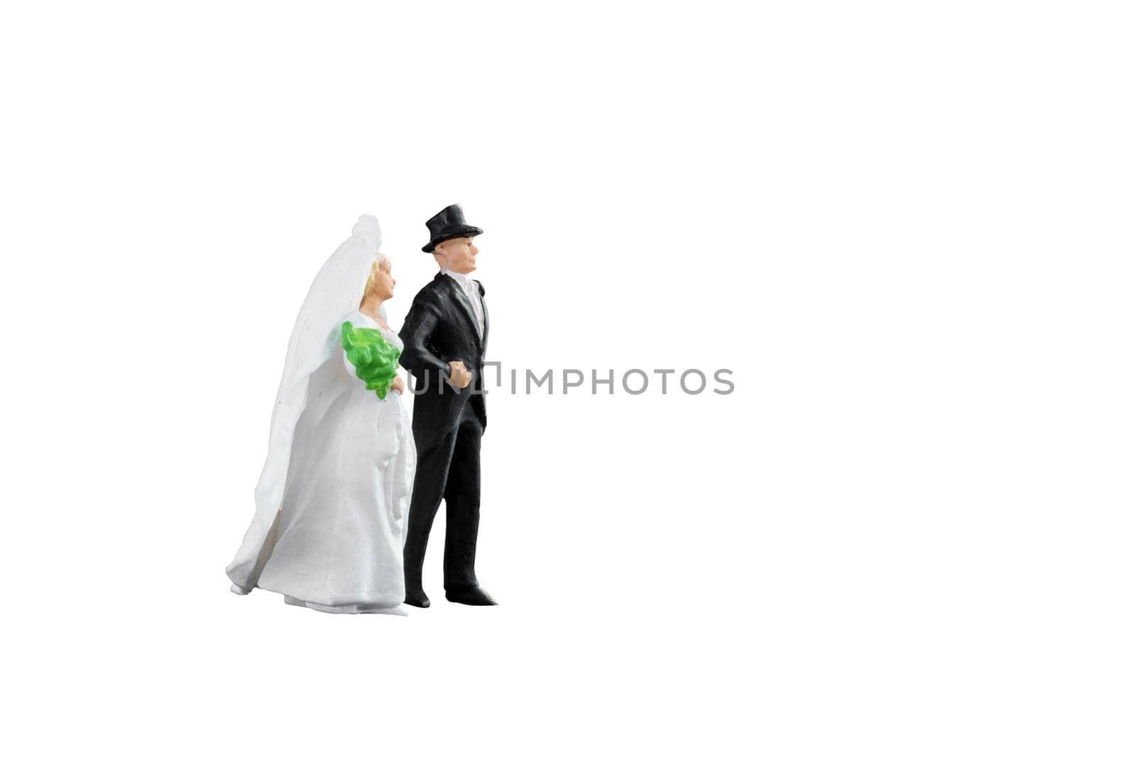 Close up of Miniature people wedding bride and groom couple isolated with clipping path on white background.Elegant Design with copy space for placement your text, mock up for love and wedding concept