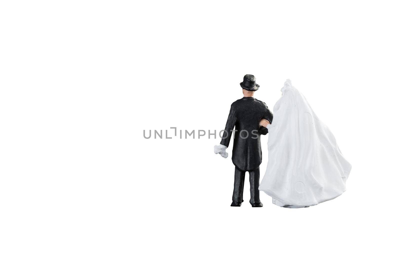 Close up of Miniature people wedding bride and groom couple isolated with clipping path on white background.Elegant Design with copy space for placement your text, mock up for love and wedding concept