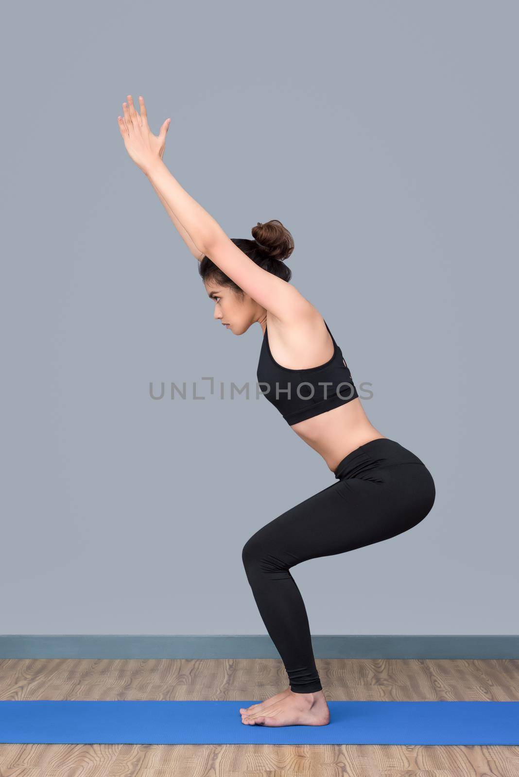 Young asian woman enjoy practicing yoga pose at yoga healthy sport gym, yoga and meditation have good benefits for health. Photo concept for Yoga Sport and Healthy lifestyle by Nuamfolio