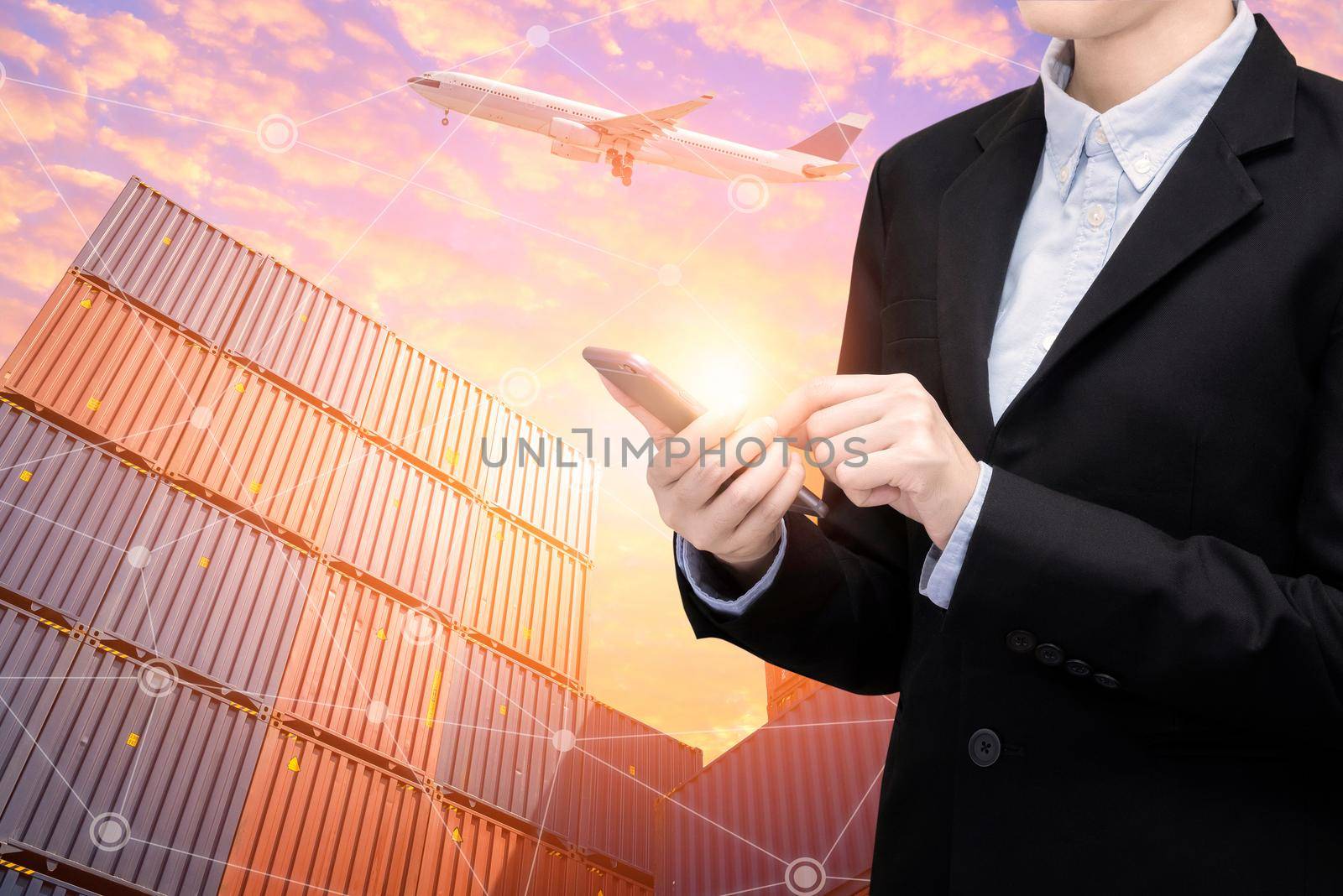 Smart Business woman use smartphone and internet of things technology for Global business connection with global customer for worldwide container cargo shipping.Logistic Import Export business concept by Nuamfolio