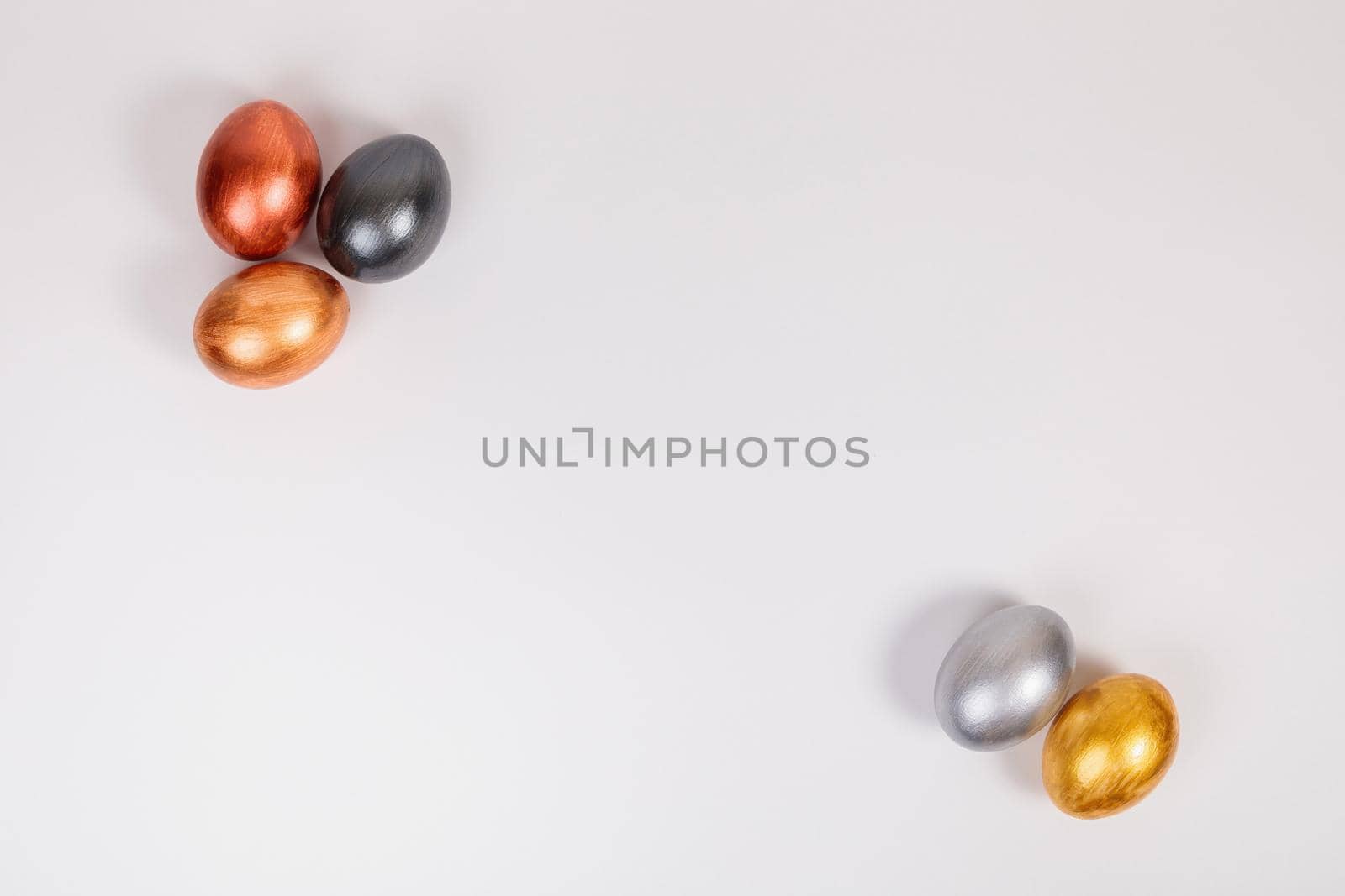 Easter. Multi-colored eggs on a uniform white background with place for text. View from above.