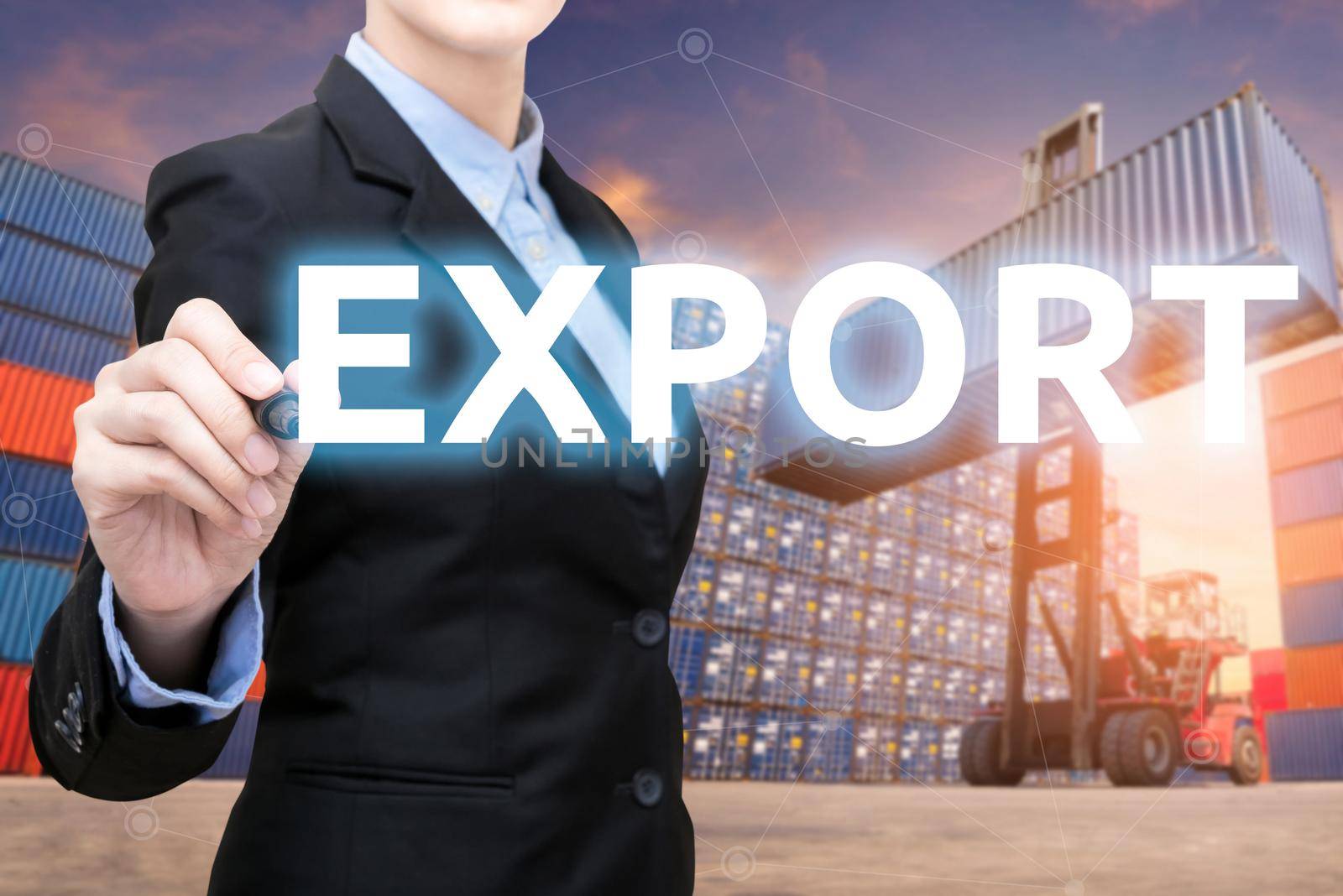 Smart business woman is writing Export word with forklift lifting cargo container and cargo containers stack in background for global transportation import,export and logistic business concept