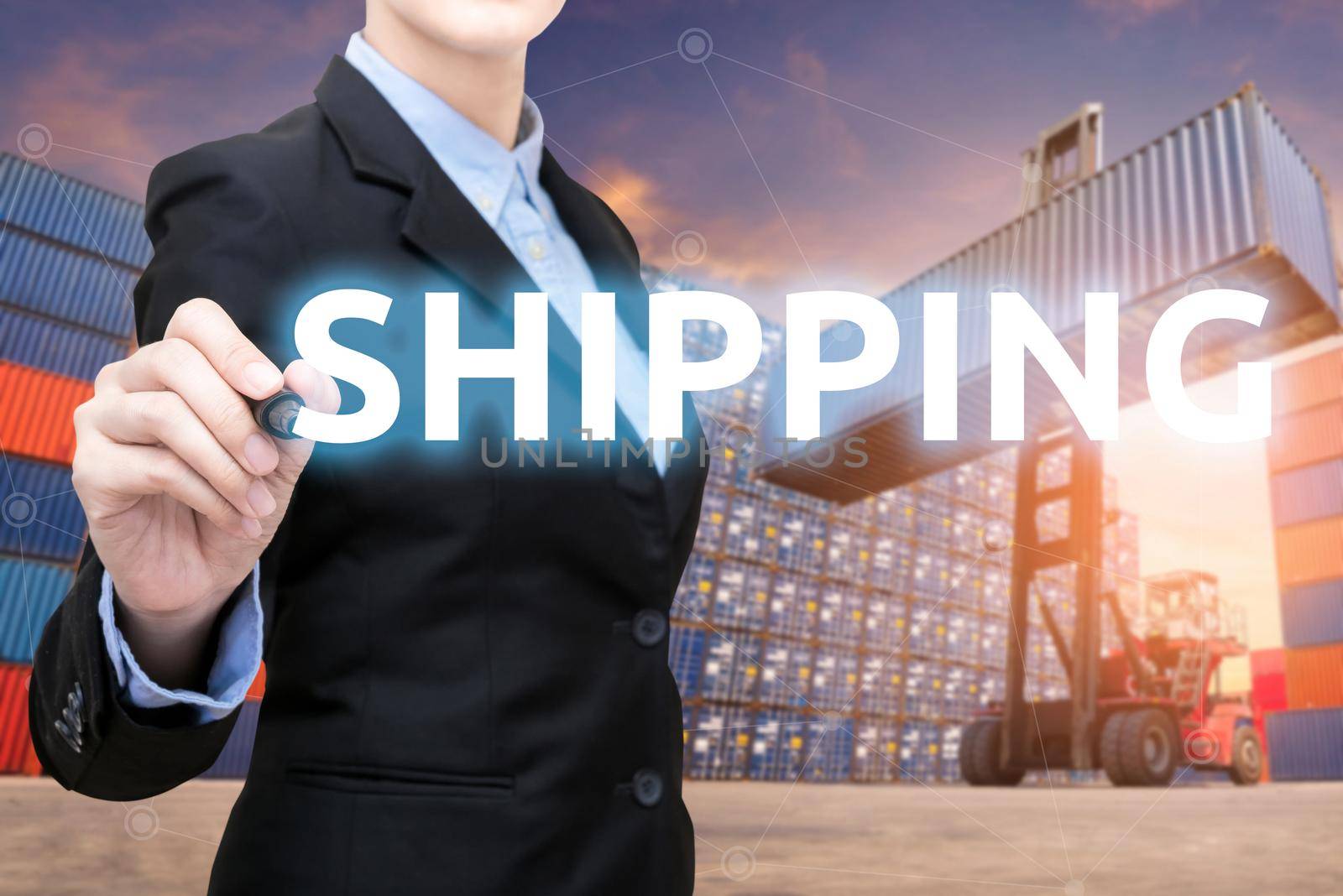 Smart business woman is writing shipping word with forklift lifting cargo container and cargo containers stack in background for global transportation import,export and logistic business concept by Nuamfolio