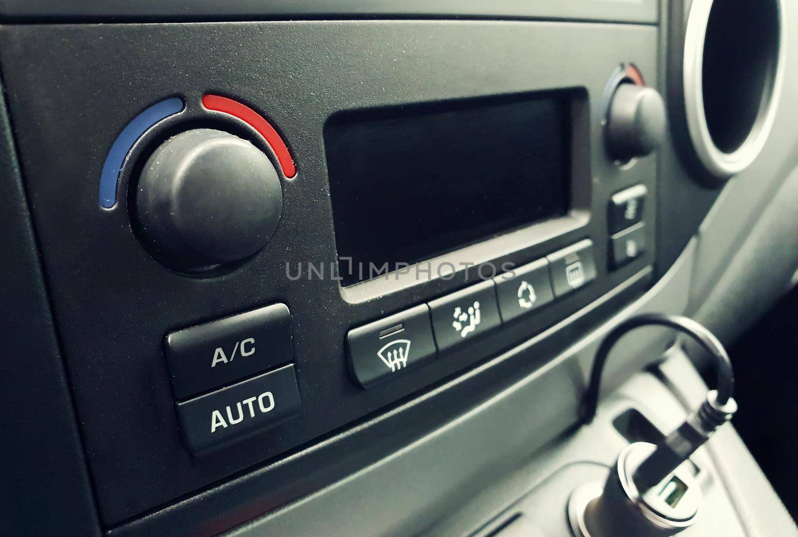 Closeup of air conditioning control buttons inside the car.