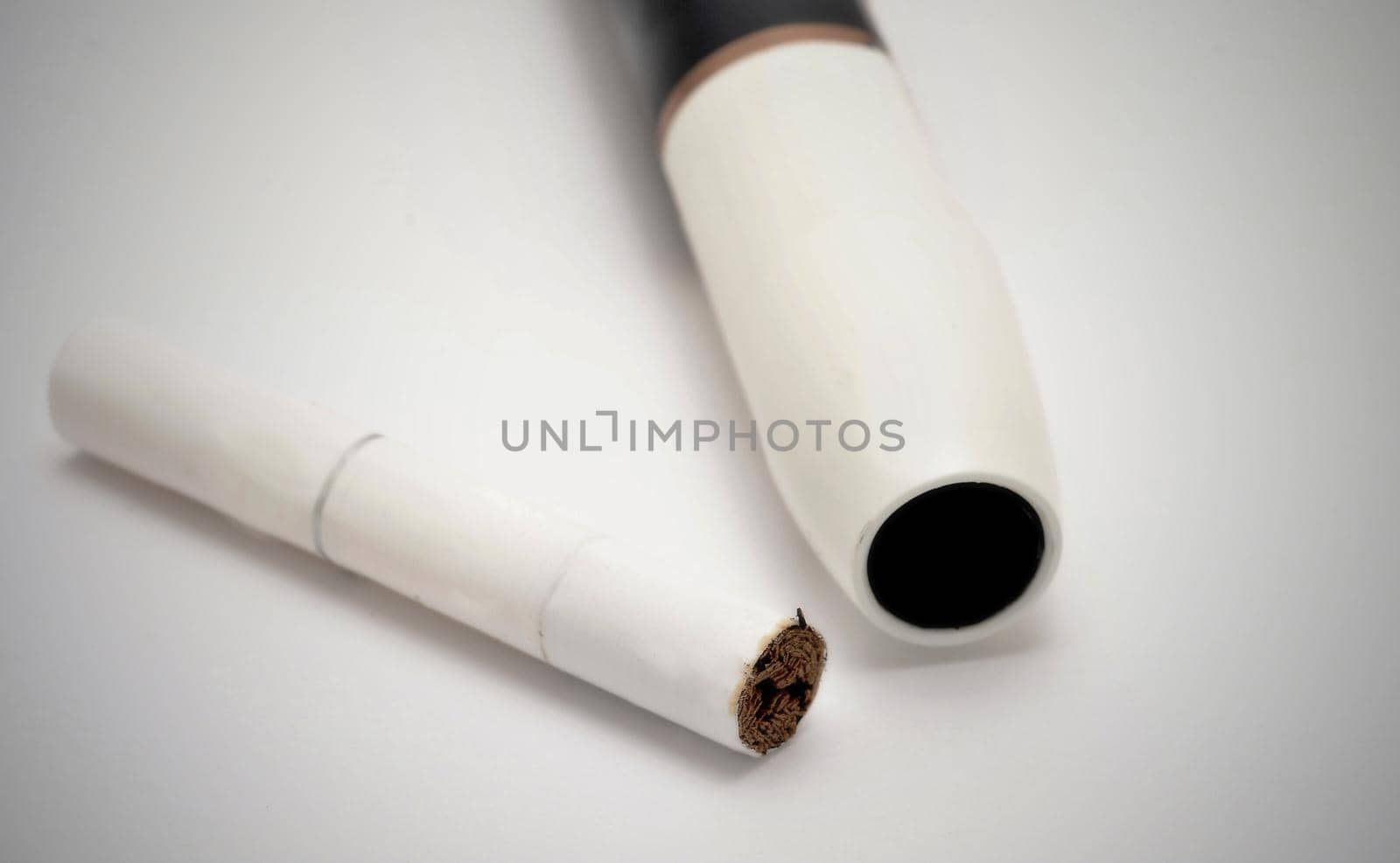 Not burn electronic cigarette heater with tobacco stick on white background.