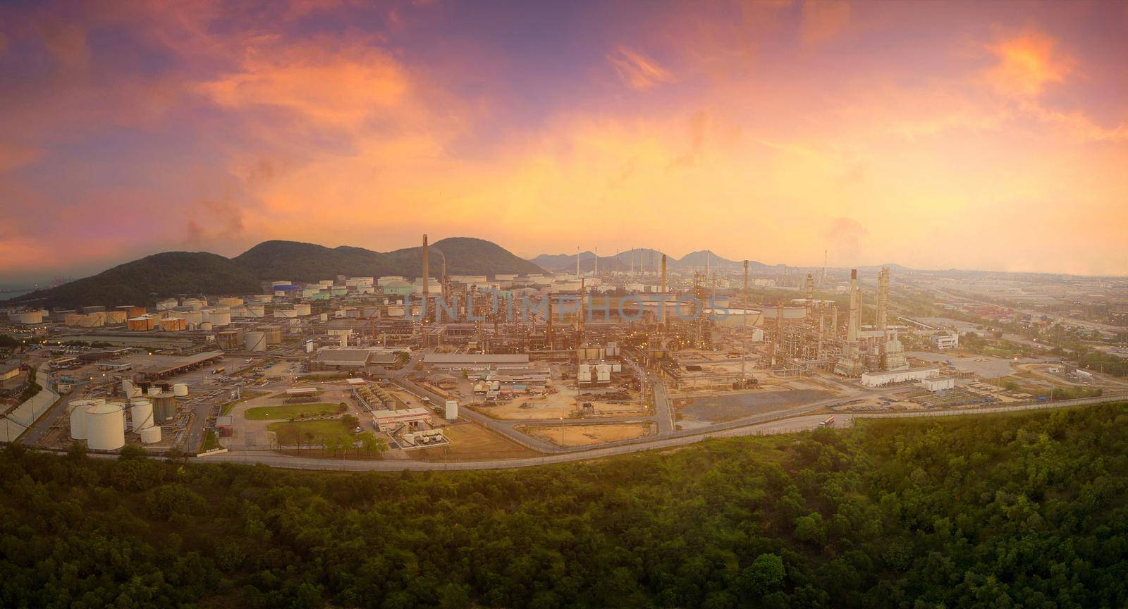 Ariel panorama view of oil and gas refinery plant of petroleum or petrochemical industry production with sunrise sky environment  by Nuamfolio