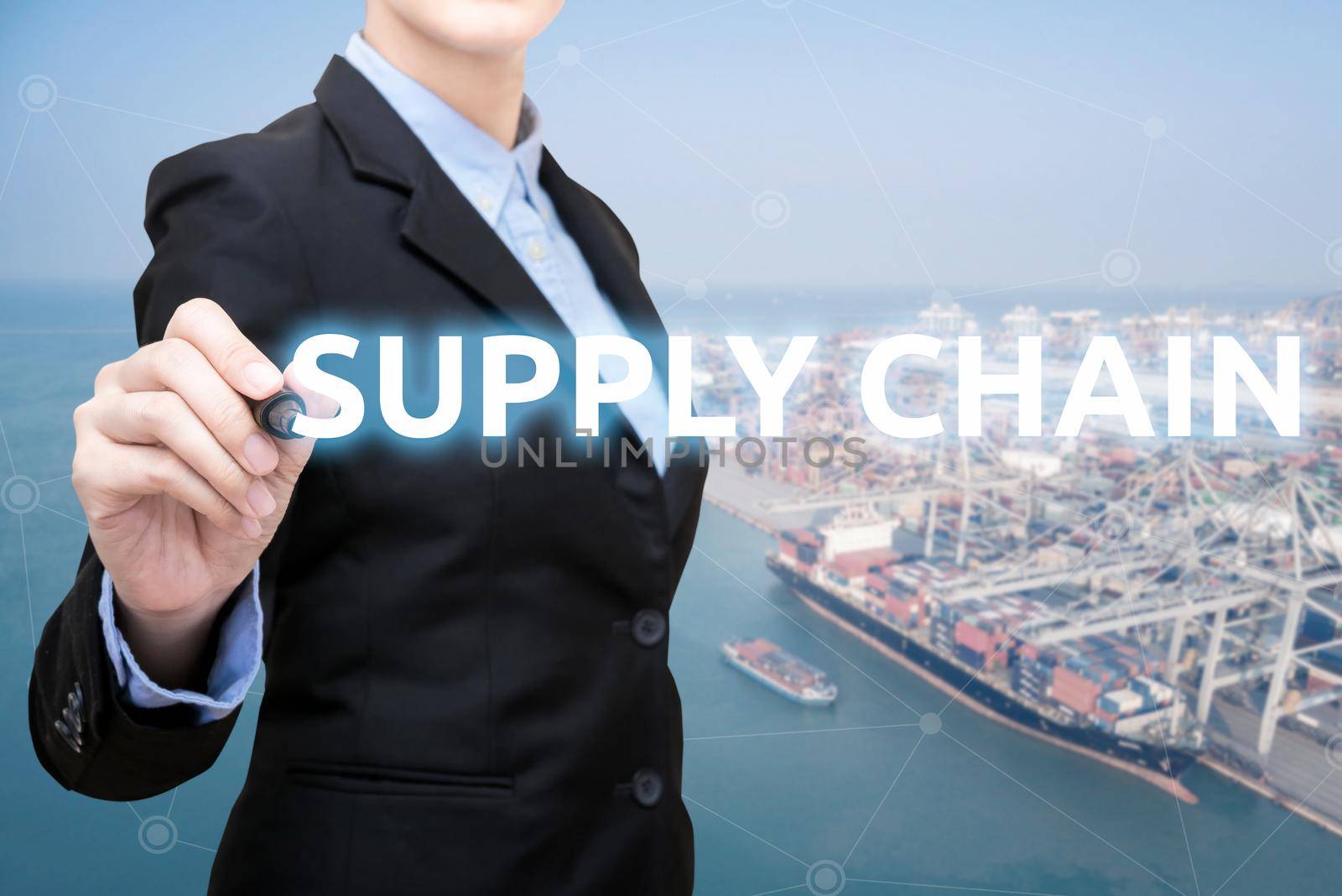 Smart Business woman is writing supply chain concept with shipping boat at shipping yard in background for Global business container cargo shipping,Logistic,Import  and Export business concept