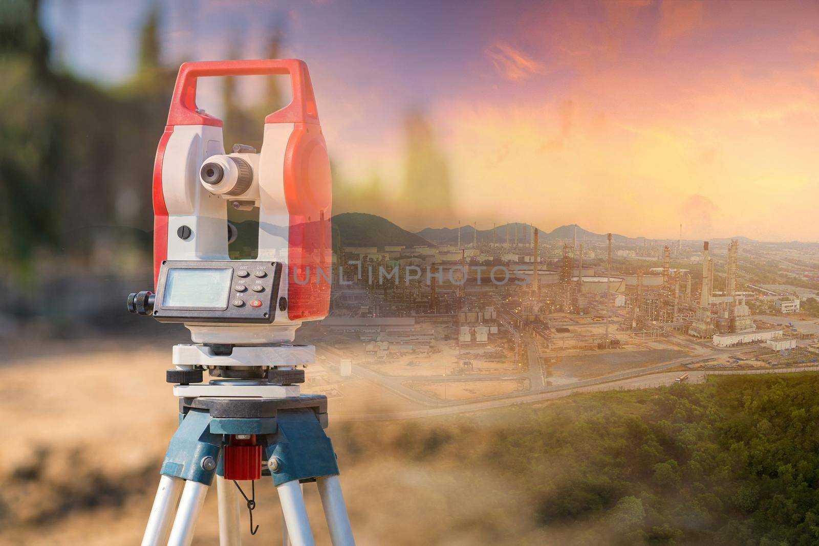 Double exposure surveyor equipment theodolite outdoors with panorama view of oil and gas refinery plant of petroleum or petrochemical industry production construction engineering work concept by Nuamfolio