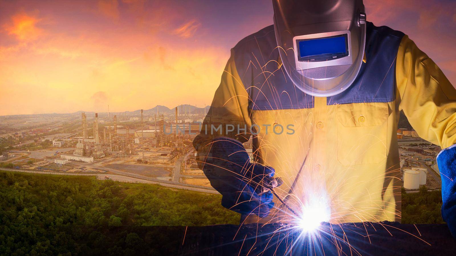 Double exposure welding worker welding steel structure with oil and gas refinery plant of petroleum or petrochemical industry production in background. by Nuamfolio