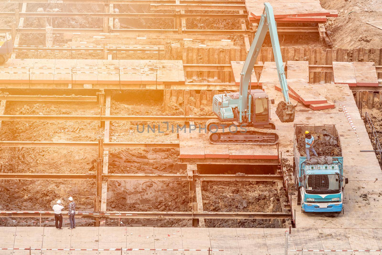 Construction engineer checking construction site with foreman worker for new Infrastructure construction project