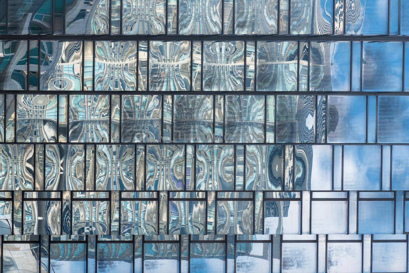 Close up of Glass structure pattern in a high rise building of modern building in business area by Nuamfolio