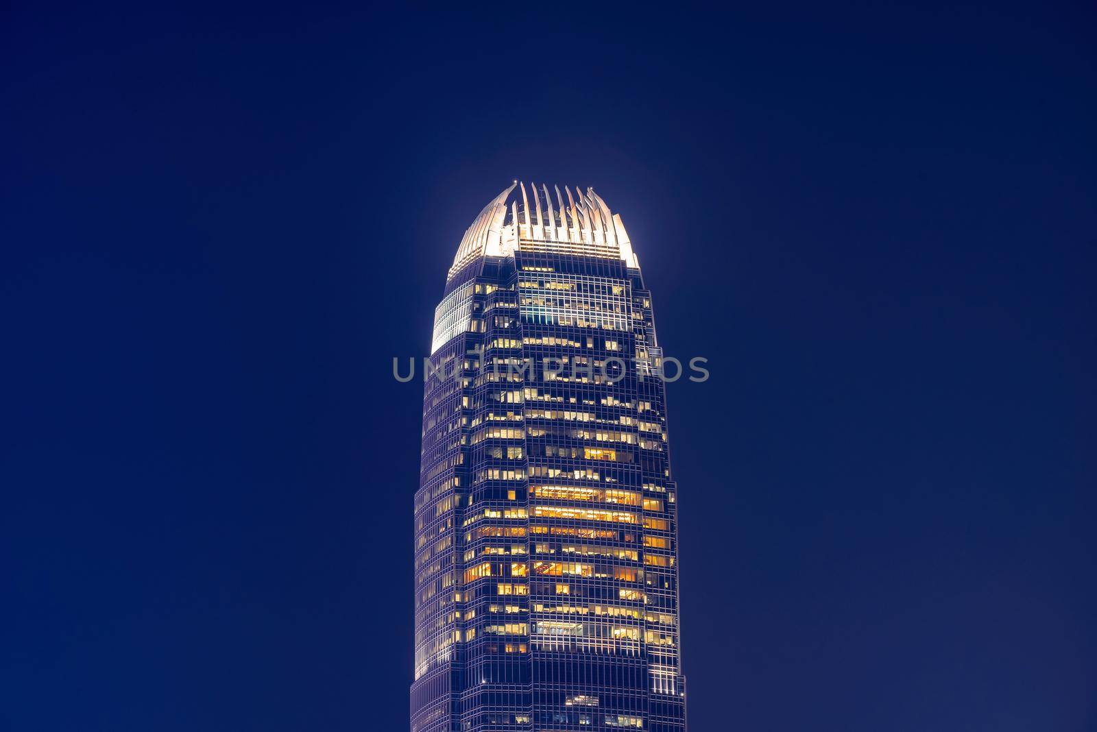 Close up view of Hong Kong landmark office building at night in Hong Kong by Nuamfolio