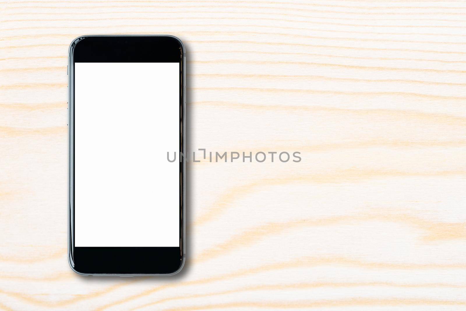 Flat lay Smartphone with blank white screen and copy-space on wood table. Elegant Design with copy space for placement your template mock up for montage your design and products