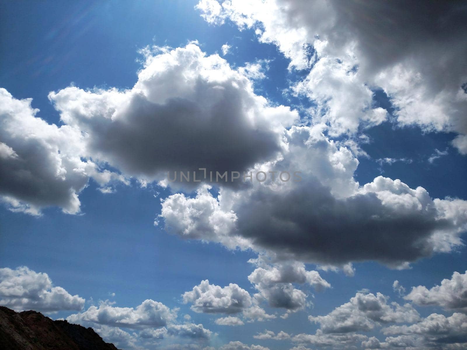 Clouds in the morning sunlight against the blue sky.