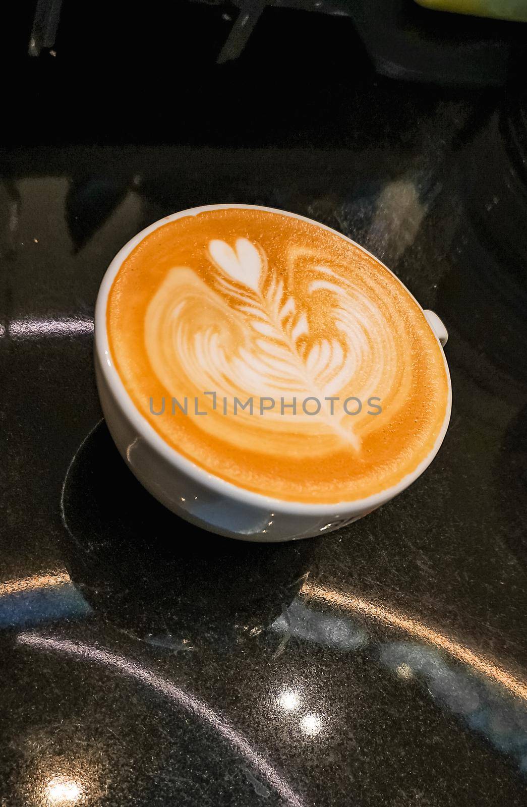 Rosette with heart latte art on coffee cup