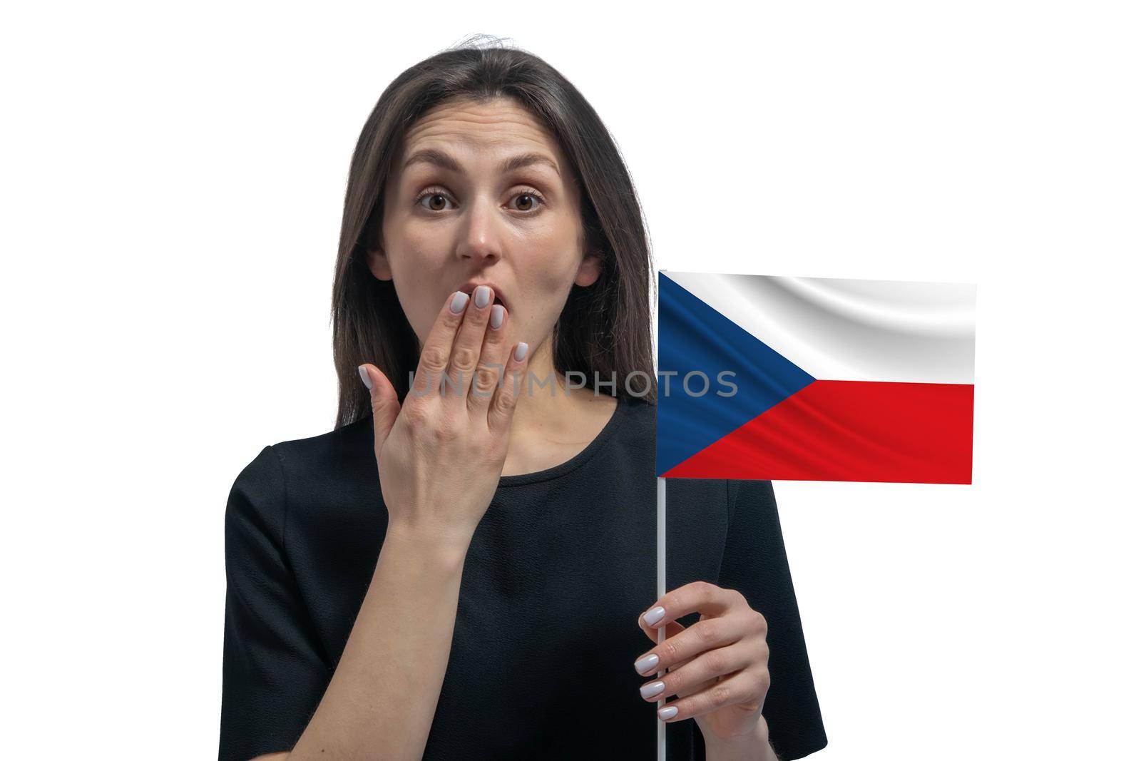 Happy young white woman holding flag of Czech Republic and covers her mouth with her hand isolated on a white background.