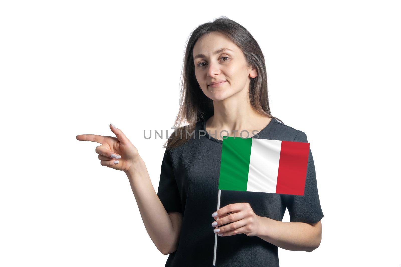 Happy young white woman holding flag Italy and points to the left isolated on a white background.