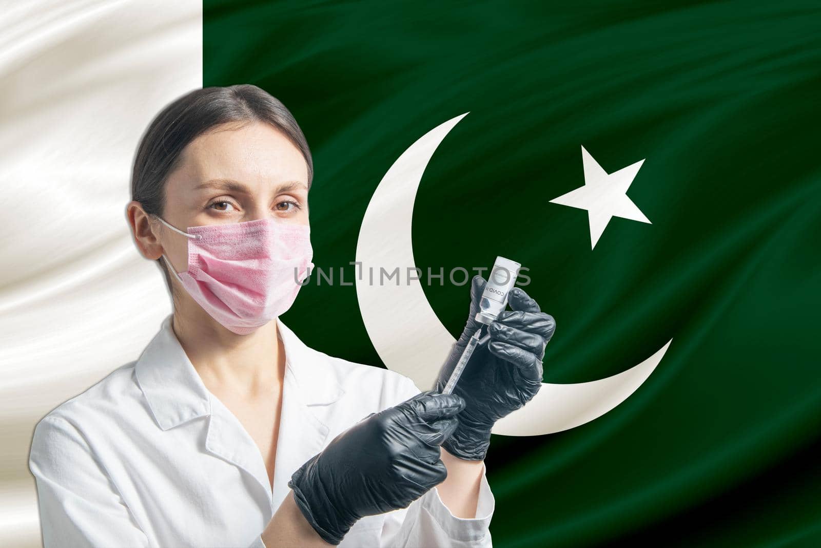 Girl doctor prepares vaccination against the background of the Pakistan flag. Vaccination concept Pakistan.