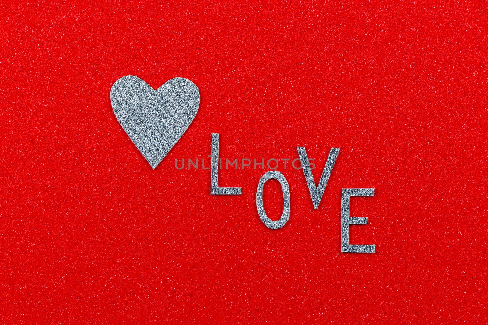 Saint Valentine's day silver heart and abstract love text on red background