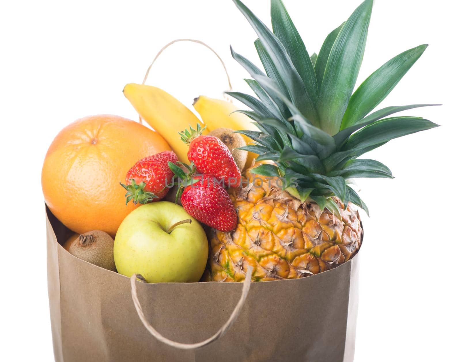 Fruits and vegetables in paper grocery bag isolated over white background
