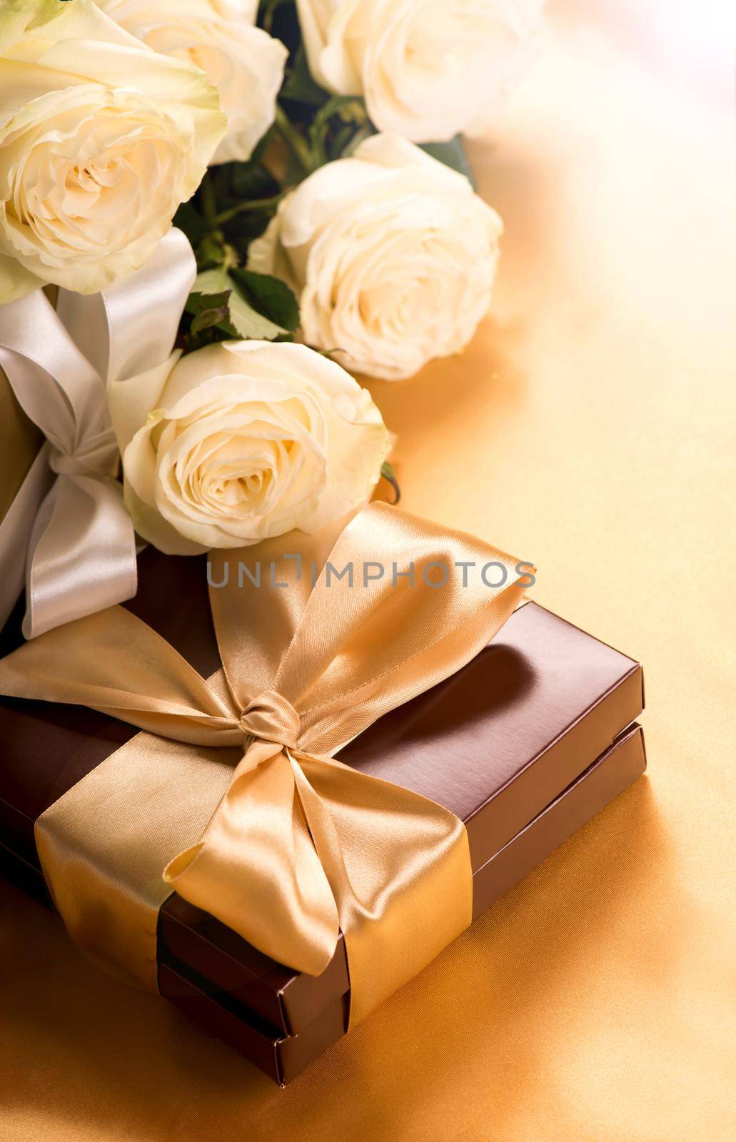 brown box with candies and golden tape by aprilphoto