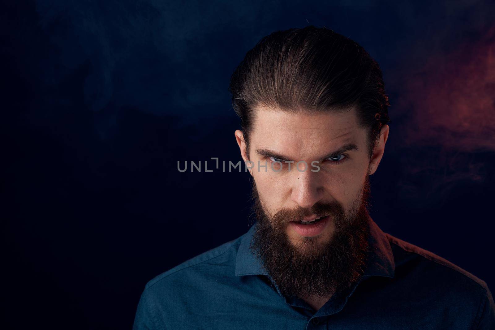 Cute bearded man in shirt elegant style close-up dark background. High quality photo