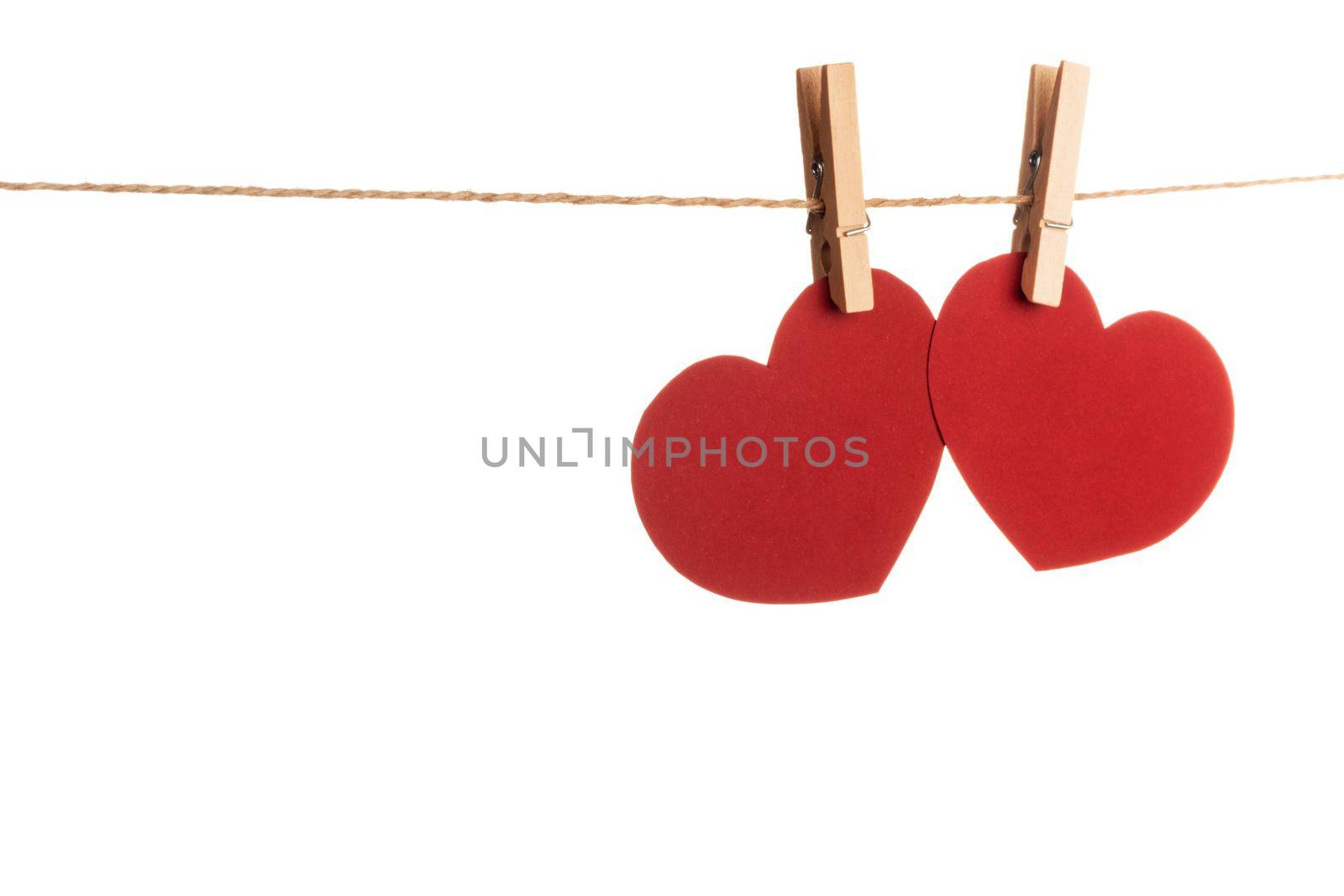 Clothes pegs and two red paper hearts by Yellowj