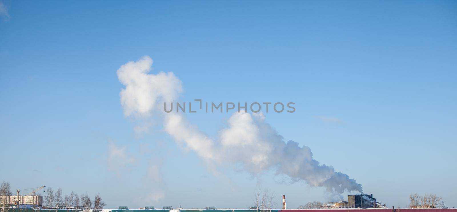 White thick smoke from the boiler room chimney. Industrial zone. by AnatoliiFoto