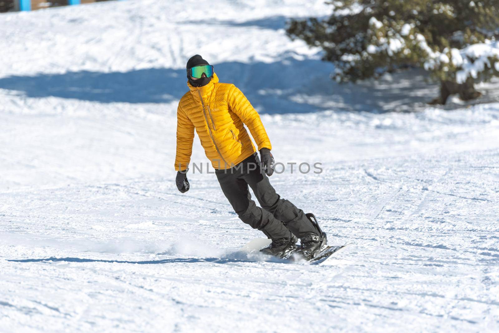 Grandvalira, Andorra: 2021 January 03: Young man on snowboard in the Pyrenees at the Grandvalira ski resort in Andorra in Covid19 time