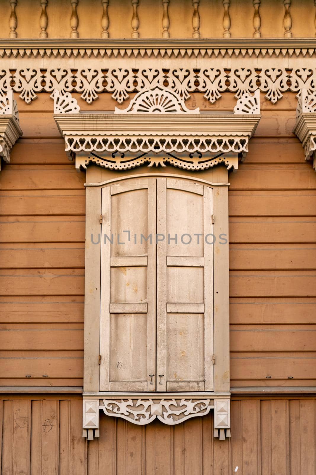 Facade of a wooden building with a window. Ancient architecture