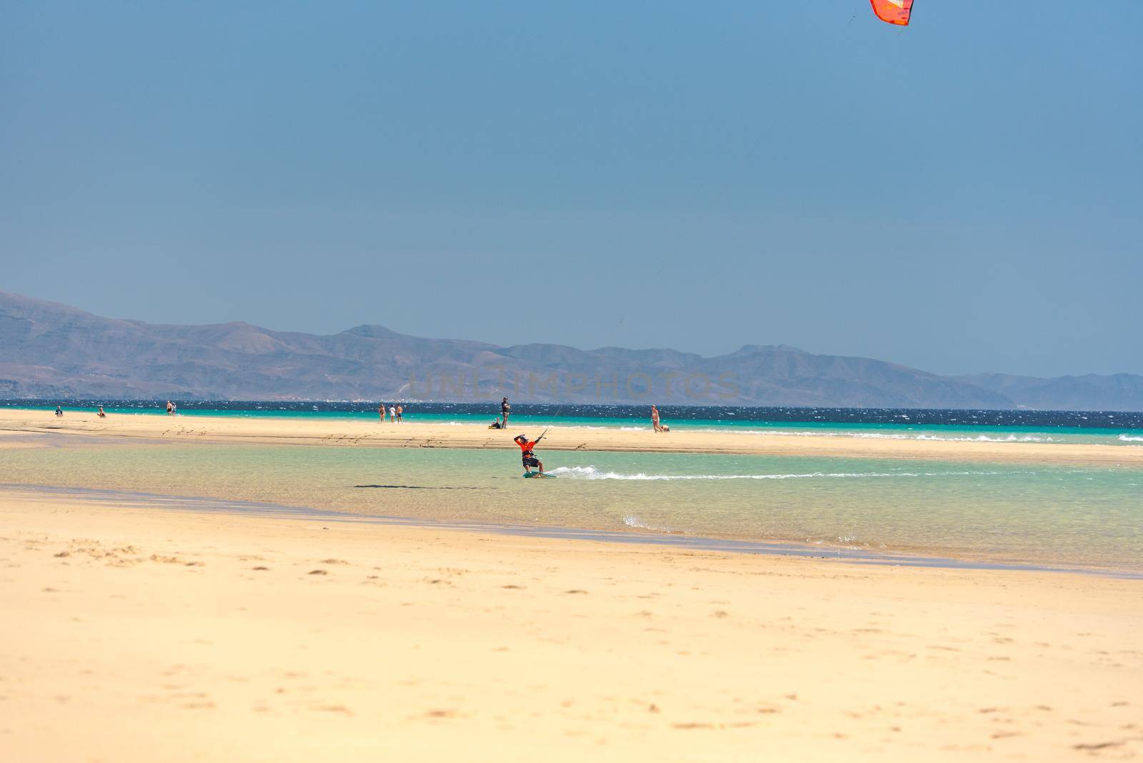 Sotavento, Fuerteventura, Spain: 2020 October 8: Man practicing kitesurfing in Playa de Sotavento, Fuerteventura in Spain in summer.