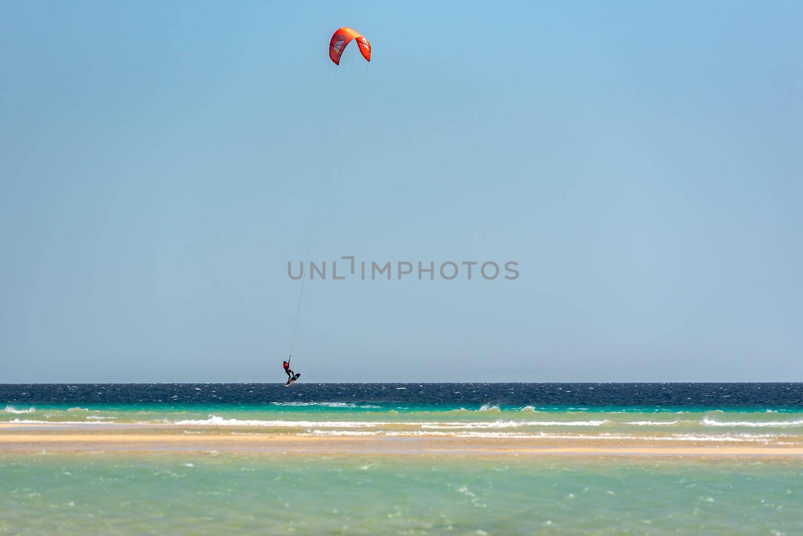 Sotavento, Fuerteventura, Spain: 2020 October 8: Man practicing kitesurfing in Playa de Sotavento, Fuerteventura in Spain in summer.