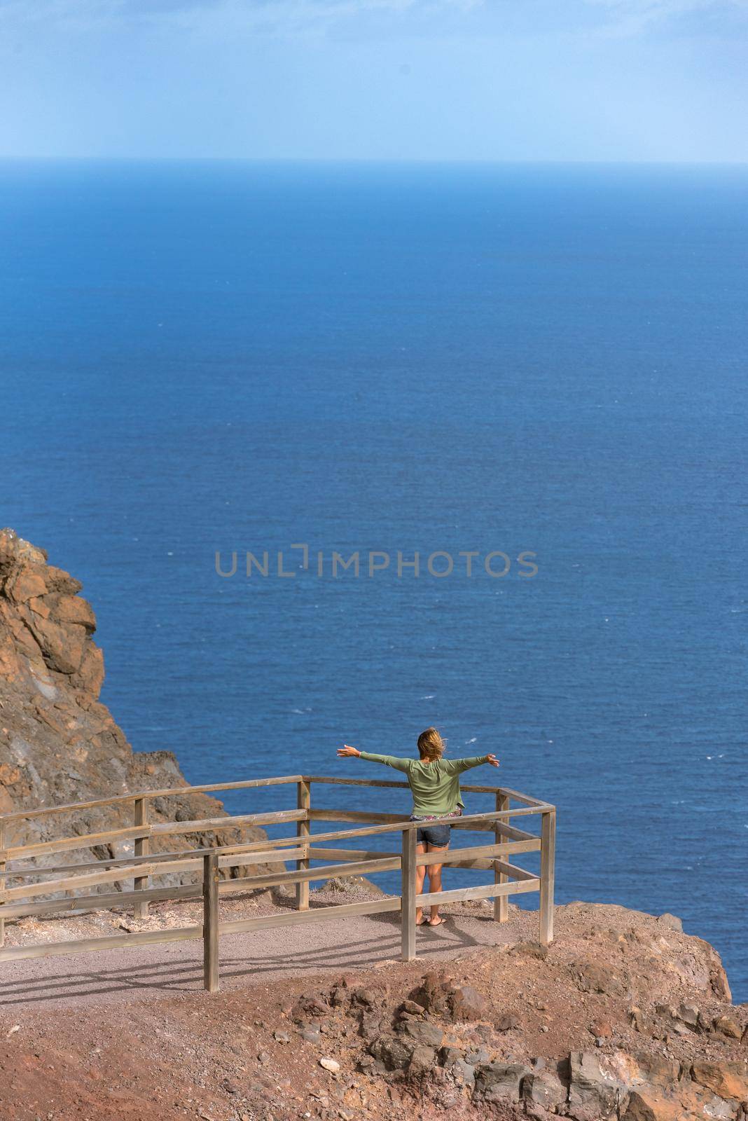 Blonde woman in the View Point in La Entallada lighthouse on the island of Fuerteventura, Spain.