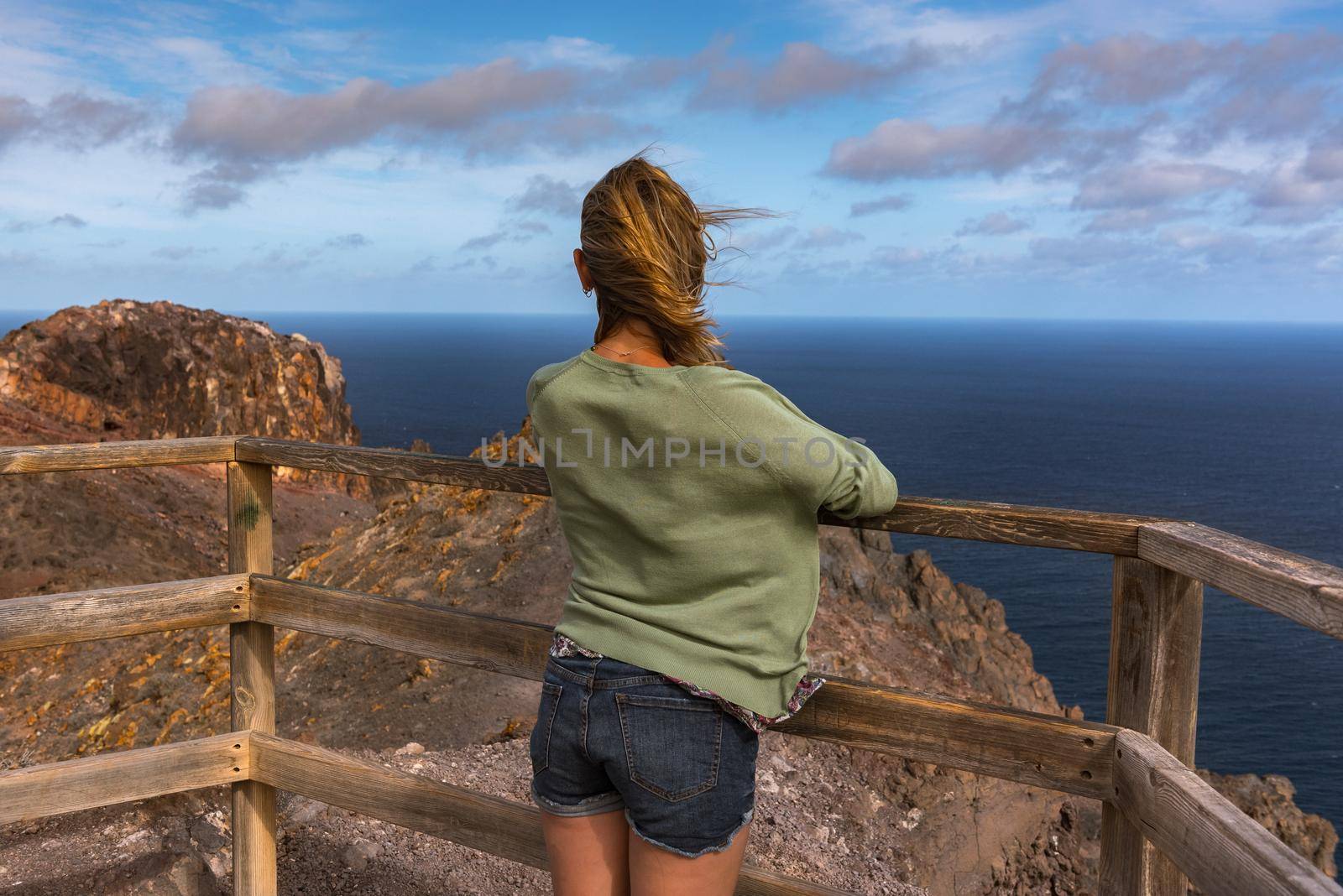 Blonde woman in the View Point in La Entallada lighthouse on the island of Fuerteventura, Spain.