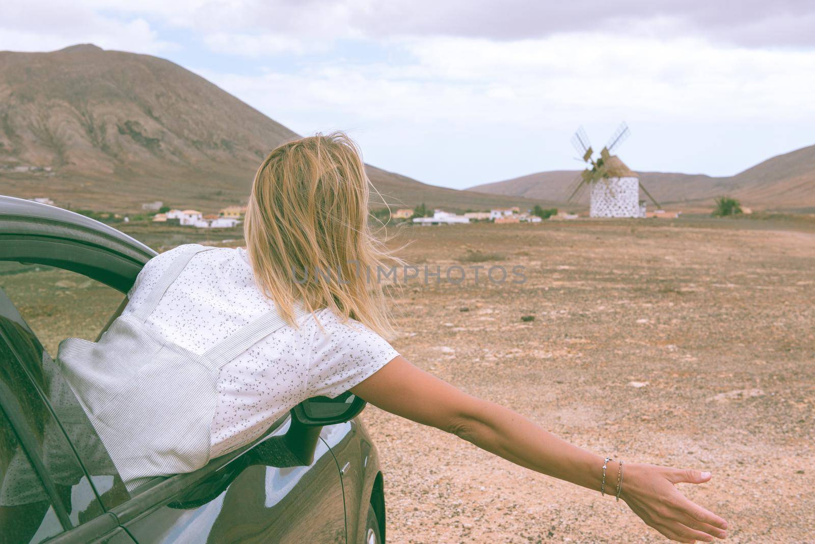 Young Blonde inside de car on the island of Fuerteventura in Spain.