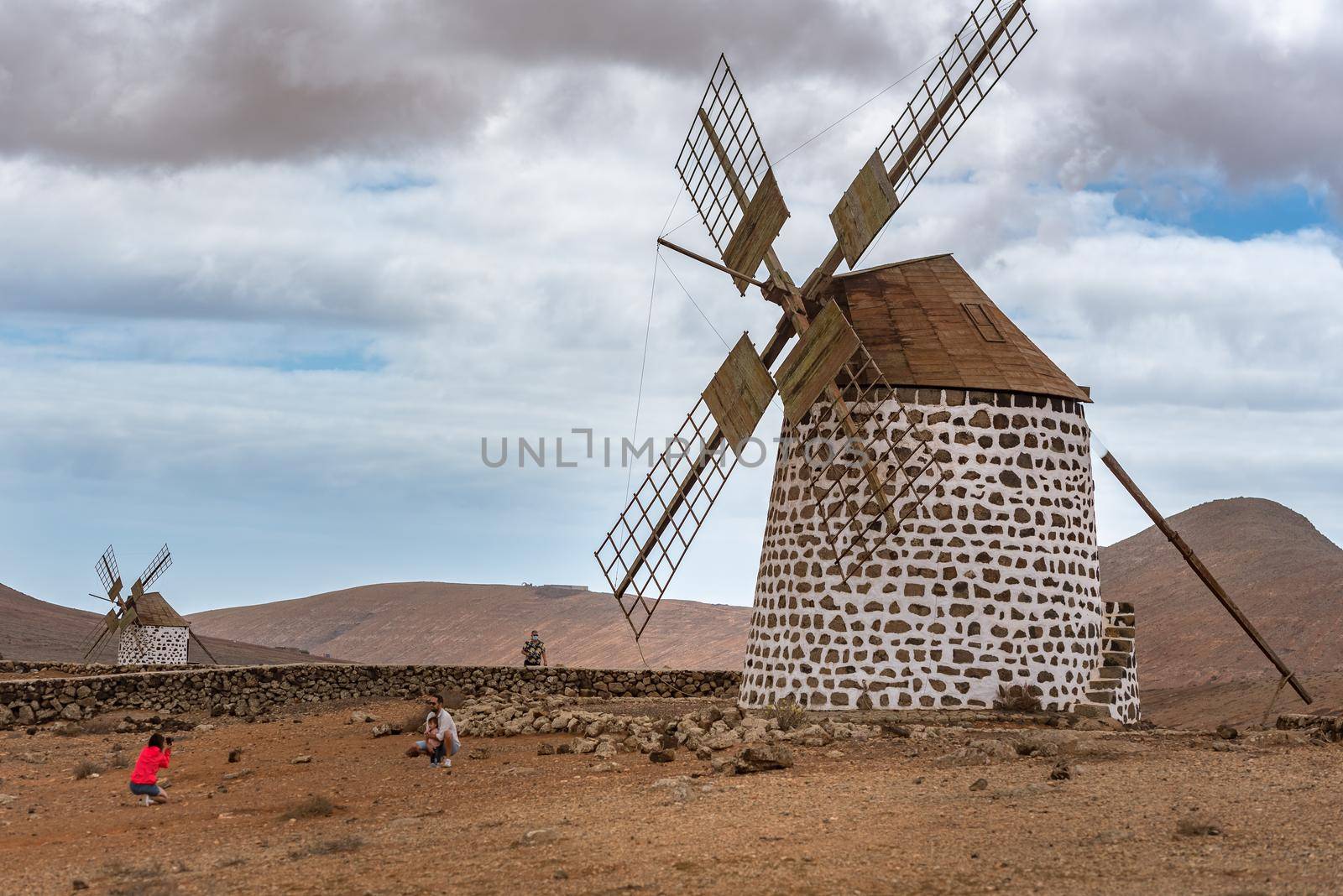 La Oliva, Fuerteventura, Spain : 2020 October 4 : Family taking a photo at the Windmills in La Oliva on the island of Fuerteventura in Spain in 2020